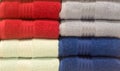 Beautiful colorful bath towels tidily folded on shelves in department store used as pattern background