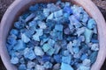 Beautiful colorful blue stones in clay vessels background Royalty Free Stock Photo