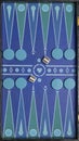 A colorful board for playing backgammon, with geometric patterns, checkers and dice Royalty Free Stock Photo