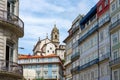 Beautiful colorful building facede in Porto Portugal with azulejo tiles and a church