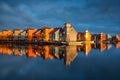 Beautiful colorful buildings on water in gold sunshine