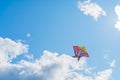 Beautiful colorful butterfly kite against the sky and clouds, freedom vacation travel concept Royalty Free Stock Photo