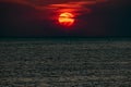 Beautiful, colorful and contrasting sunset over the sea, ocean. The hot sun illuminates the spacious landscape, casting the glare Royalty Free Stock Photo