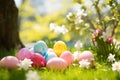 Beautiful colorful eggs and flowers in spring grass meadow over blue sky with sun Royalty Free Stock Photo