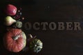 Beautiful colorful fall flat lay with leaves, pumpkins, chestnuts and letters october on wooden background Royalty Free Stock Photo