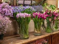 Beautiful colorful flowers for sale, placed in vases in flower shop. Tulips, roses and limonium Royalty Free Stock Photo