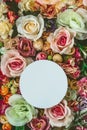 Beautiful colorful flowers wall background, with white circle greeting card with copy space; Spring, wedding, anniversary or flori Royalty Free Stock Photo