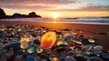 Beautiful and Colorful glass pebbles on the beach with sunset scene and sea waves Royalty Free Stock Photo
