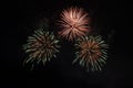 Beautiful colorful holiday fireworks on the black sky background, long exposure Royalty Free Stock Photo