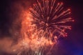 Beautiful colorful holiday fireworks in the evening sky with majestic clouds Royalty Free Stock Photo