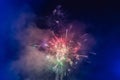 Beautiful colorful holiday fireworks in the evening sky with majestic clouds Royalty Free Stock Photo