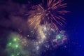 Beautiful colorful holiday fireworks in the evening sky with majestic clouds Royalty Free Stock Photo