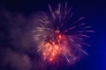 Beautiful colorful holiday fireworks in the evening sky with majestic clouds Royalty Free Stock Photo