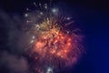 Beautiful colorful holiday fireworks in the evening sky with majestic clouds Royalty Free Stock Photo
