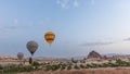 Beautiful colorful hot air balloons take off and flying in clear morning sky timelapse in Cappadocia, Turkey Royalty Free Stock Photo