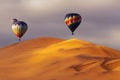 Beautiful Colorful Hot Air Baloons and dramatic clouds over the sand dunes in the desert Royalty Free Stock Photo