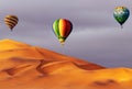 Beautiful Colorful Hot Air Baloons and dramatic clouds over the sand dunes in the desert Royalty Free Stock Photo