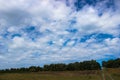 Beautiful colorful kite flying in a blue cloudy sky Royalty Free Stock Photo