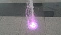 Beautiful and colorful light water fountain over concrete floor