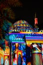 Beautiful colorful lights with Middle Eastern patterns and drawings displayed on a mosque - Sharjah lights festival Royalty Free Stock Photo