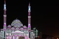 Beautiful colorful lights with Middle Eastern patterns and drawings displayed on a mosque - Sharjah lights festival Royalty Free Stock Photo