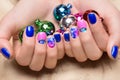 Beautiful colorful manicure with bubbles and crystals on female hand. Close-up.