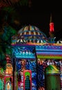 Beautiful colorful Middle Eastern patterns displayed on a mosque in the city at night - Sharjah lights festival