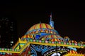 Beautiful colorful Middle Eastern patterns displayed on a mosque in the city at night - Sharjah lights festival