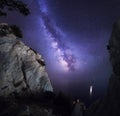 Beautiful colorful night landscape with Milky Way, rocks, sea and starry sky. Mountain landscape. Amazing universe. Royalty Free Stock Photo