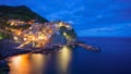 Beautiful colorful panoramic photo of village Manarola by night in Cinque Terre, Italy. Royalty Free Stock Photo