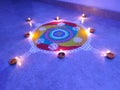 Beautiful and colorful rangoli made in diwali festival celebrated in india. decorated with hand made diyas.