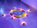 Beautiful and colorful rangoli made in diwali festival celebrated in india. decorated with hand made diyas.