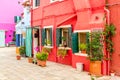 Beautiful colorful red small house with plants in Burano island near Venice, Italy Royalty Free Stock Photo