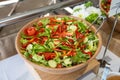 beautiful and colorful salad filled with lettuce greens cucumbers tomatoes red and green peppers at a catering event Royalty Free Stock Photo
