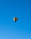 beautiful and colorful shot of hot air balloon with basket and blue sky in background Royalty Free Stock Photo