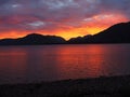 Beautiful colorful shot of the sunset behind the mountains of loch beach in scotland