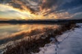 Beautiful colorful sky during sunrise on cold winter morning. Frozen water on dam Liptovska Mara, Slovakia Royalty Free Stock Photo