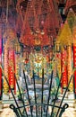 Beautiful colorful spiritual vietnamese temple, incense spirals and historical spears, red pillars with chinese script