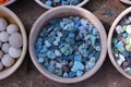 Beautiful colorful stones in clay vessels close up for background