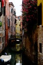 Beautiful colorful street with flowers, canal and boat