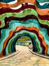 Colorful striped archway over path at garden