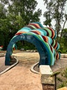 Colorful striped archway over path at garden