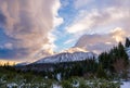 Beautiful colorful sunrise over the snowy mountain range and pine tree forest. Nature landscape. Dramatic overcast sky in Tatra Royalty Free Stock Photo