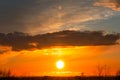 Beautiful colorful sunrise at the sea with dramatic clouds and sun shining. Dramatic sunset sky with orange colored clouds and sun Royalty Free Stock Photo