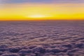 Beautiful and colorful sunset above purple color clouds. Looking through an airplane window. Royalty Free Stock Photo