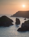 Stunning vibrant sunset landscape image of Kynance Cove on South