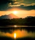 A beautiful, colorful sunset landscape with lake, mountain and forest. Natural evening scenery over the mountain lake in summer. Royalty Free Stock Photo