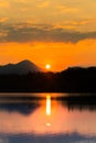 A beautiful, colorful sunset landscape with lake, mountain and forest. Natural evening scenery over the mountain lake in summer. Royalty Free Stock Photo