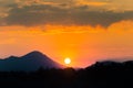 A beautiful, colorful sunset landscape with lake, mountain and forest. Natural evening scenery over the mountain lake in summer. Royalty Free Stock Photo