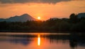 A beautiful, colorful sunset landscape with lake, mountain and forest. Natural evening scenery over the mountain lake in summer. Royalty Free Stock Photo